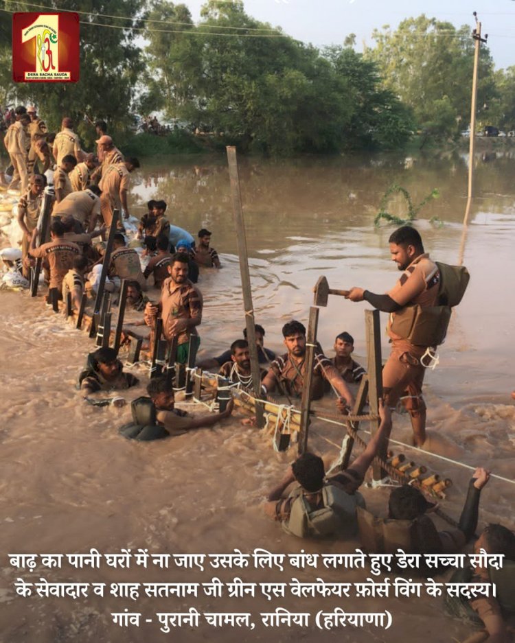 Fueled by the spirit to serve mankind, 2000 Dera Sacha Sauda volunteers forge a 20-feet deep sandbag embankment in the Ghaggar River to save flood victims